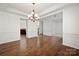 Spacious living room with hardwood floors, chandelier lighting and detailed trim work at 8025 Penman Springs Dr, Waxhaw, NC 28173