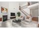 Bright living room featuring a fireplace, a staircase, and a cozy seating area at 8025 Penman Springs Dr, Waxhaw, NC 28173