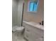 Bright bathroom featuring a tiled shower, toilet, vanity with countertop, and window at 811 Sanford St, Marshville, NC 28103