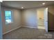 Inviting bedroom with adjacent bathroom featuring a window and carpeted flooring at 811 Sanford St, Marshville, NC 28103