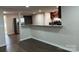 Open-concept living space with sleek flooring, breakfast bar, and stainless steel appliances at 811 Sanford St, Marshville, NC 28103