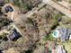 An expansive aerial view showcases a serene neighborhood with generously sized properties and mature trees at 8328 Victoria Lake Dr, Waxhaw, NC 28173