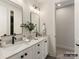 Bright bathroom features double sinks, quartz countertops, black fixtures, and updated lighting at 8328 Victoria Lake Dr, Waxhaw, NC 28173