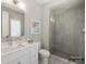 Neutral bathroom with white vanity, and glass shower with gray tile surround and hexagon tile floor at 8328 Victoria Lake Dr, Waxhaw, NC 28173