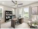 Bright home office with large windows, modern desk, shelves, and comfortable seating at 8328 Victoria Lake Dr, Waxhaw, NC 28173
