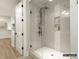 Modern shower with a glass enclosure, sleek fixtures, built-in shelving, and stylish tile work at 8328 Victoria Lake Dr, Waxhaw, NC 28173