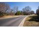 A tranquil neighborhood street scene showcasing lush greenery, clear skies, and a welcoming atmosphere at 8328 Victoria Lake Dr, Waxhaw, NC 28173