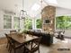 Inviting sunroom featuring a stone fireplace, a dining table and comfortable seating, filled with natural light at 8328 Victoria Lake Dr, Waxhaw, NC 28173