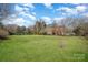 Expansive backyard is surrounded by mature trees for a private outdoor space at 9423 Belmont Ln, Marvin, NC 28173