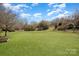 Large backyard is surrounded by mature trees for a private outdoor space at 9423 Belmont Ln, Marvin, NC 28173