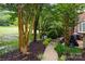 View of backyard with garden and walkway to the patio behind the house at 9423 Belmont Ln, Marvin, NC 28173