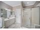 Bathroom with glass shower, modern vanity, and neutral tile floors at 9423 Belmont Ln, Marvin, NC 28173
