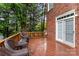A spacious wooden deck includes wicker seating and door to the brick house at 9423 Belmont Ln, Marvin, NC 28173