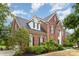Charming two-story home showcasing a well-manicured lawn and classic brick facade at 9423 Belmont Ln, Marvin, NC 28173
