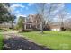 Spacious home with a sprawling lawn and driveway, perfect for outdoor activities at 9423 Belmont Ln, Marvin, NC 28173