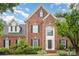 Charming brick two-story home featuring black shutters and a lush, landscaped front yard at 9423 Belmont Ln, Marvin, NC 28173
