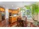 Bright kitchen with wood cabinets, granite countertops, and a central island with seating at 9423 Belmont Ln, Marvin, NC 28173