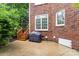 A concrete patio features stairs to the deck and a grill under a cover at 9423 Belmont Ln, Marvin, NC 28173
