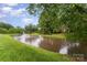 Picturesque pond features a fountain and lush green landscaping for relaxing at 9423 Belmont Ln, Marvin, NC 28173