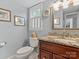 Charming bathroom featuring a classic vanity with granite countertop, framed mirror, and a window with custom shutters at 9601 Whitethorn Dr, Charlotte, NC 28277