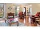 Cozy living room featuring hardwood floors, comfortable seating, and natural light at 9601 Whitethorn Dr, Charlotte, NC 28277