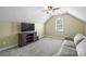 Well-lit bonus room features a large TV, comfortable seating, and natural light, perfect for entertainment at 9627 Baileywick Rd, Charlotte, NC 28277