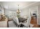 Formal dining room featuring wainscoting, chandelier and plantation shutters at 9627 Baileywick Rd, Charlotte, NC 28277