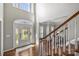 Bright foyer with hardwood floors, staircase and decorative glass front door at 9627 Baileywick Rd, Charlotte, NC 28277