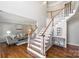Bright foyer with hardwood floors, staircase and view to living room at 9627 Baileywick Rd, Charlotte, NC 28277