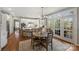 Bright kitchen featuring white cabinets, an island with seating, and an adjacent breakfast nook at 9627 Baileywick Rd, Charlotte, NC 28277