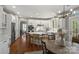 Open-concept kitchen with island seating, stainless steel appliances, and hardwood floors at 9627 Baileywick Rd, Charlotte, NC 28277