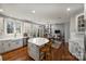 Well-lit kitchen with a center island, stainless appliances, and hardwood flooring at 9627 Baileywick Rd, Charlotte, NC 28277