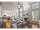 Cozy living room with a fireplace, high ceilings, and multiple windows at 9627 Baileywick Rd, Charlotte, NC 28277
