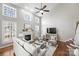 Open-concept living room with kitchen and dining area, fireplace, and abundant natural light at 9627 Baileywick Rd, Charlotte, NC 28277