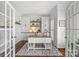 Well-lit home office with built-in cabinets, shelves, plantation shutters and french doors at 9627 Baileywick Rd, Charlotte, NC 28277