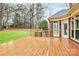 Wooden deck with railings offers outdoor living space, overlooking a well-maintained lawn at 9800 Deer Brook Ln, Charlotte, NC 28210