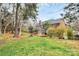 Scenic backyard with a wooden deck, expansive lawn, and privacy fence at 9800 Deer Brook Ln, Charlotte, NC 28210