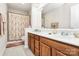 Bathroom with a double sink vanity and shower with floral shower curtain at 9800 Deer Brook Ln, Charlotte, NC 28210