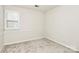 Empty bedroom with neutral carpet and wall color, and window with shutters at 9800 Deer Brook Ln, Charlotte, NC 28210