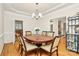 Formal dining room with hardwood floors, elegant lighting, and seating for six at 9800 Deer Brook Ln, Charlotte, NC 28210