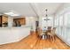 Bright dining room with hardwood floors, stylish chandelier, and shuttered windows at 9800 Deer Brook Ln, Charlotte, NC 28210