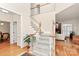 Bright foyer with hardwood floors, a staircase, and an open view into other rooms at 9800 Deer Brook Ln, Charlotte, NC 28210