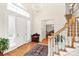 Bright foyer with hardwood floors, a staircase, and a decorative chandelier at 9800 Deer Brook Ln, Charlotte, NC 28210