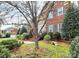 Charming brick home with a landscaped front yard, walkway, and a decorative bench at 9800 Deer Brook Ln, Charlotte, NC 28210
