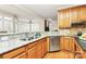 Well-lit kitchen featuring granite counters, stainless steel appliances, and hardwood floors at 9800 Deer Brook Ln, Charlotte, NC 28210