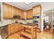 Charming kitchen with stainless steel appliances, hardwood floors, and a movable center island at 9800 Deer Brook Ln, Charlotte, NC 28210