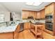 Well-appointed kitchen featuring stainless steel appliances, granite countertops, and center island at 9800 Deer Brook Ln, Charlotte, NC 28210