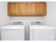 Laundry room with top load washer and dryer and upper cabinets for storage at 9800 Deer Brook Ln, Charlotte, NC 28210