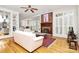 Cozy living room featuring a classic brick fireplace, hardwood floors, and built-in shelving at 9800 Deer Brook Ln, Charlotte, NC 28210