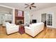 Spacious living room featuring a brick fireplace, bright windows, and hardwood flooring at 9800 Deer Brook Ln, Charlotte, NC 28210